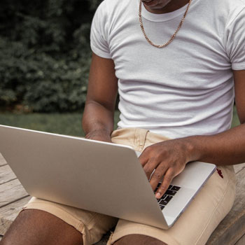 A man scrolling through his laptop