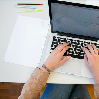 Person Doing a Research with a laptop on table