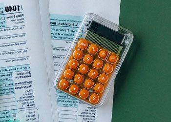 ACT permitted calculator and test papers sitting on a table