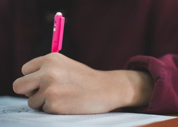 A person writing on a paper