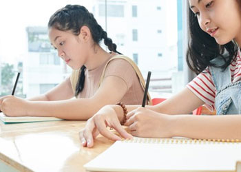 Students writing in a classroom