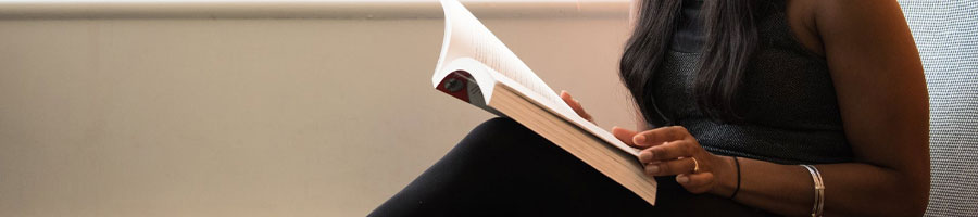 A female student having a read in a library