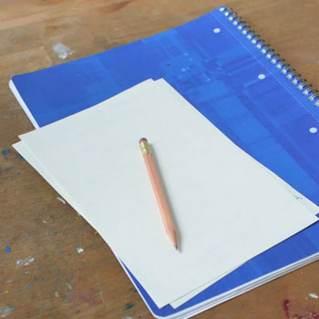 A pencil and notebook on a table