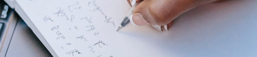 A close up image of a hand writing