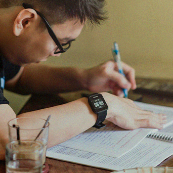 A student writing on his notebook