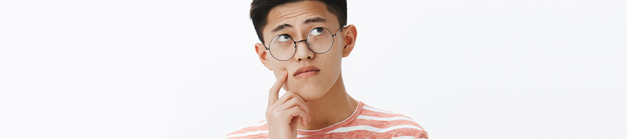 A student with glasses thinking