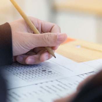 Close up view of a person answering an exam paper