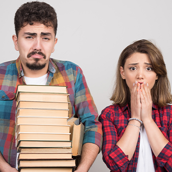 A student holding a stack of books