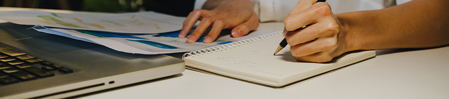 A person busy writing down notes