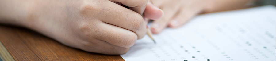 Close up image of a student answering an exam