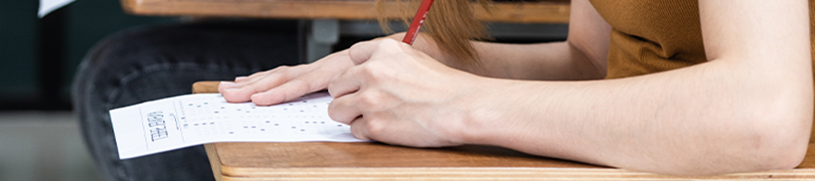 A woman taking an exam in a class