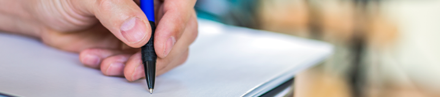 A person writing on a blank paper