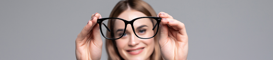 Woman holding her glasses