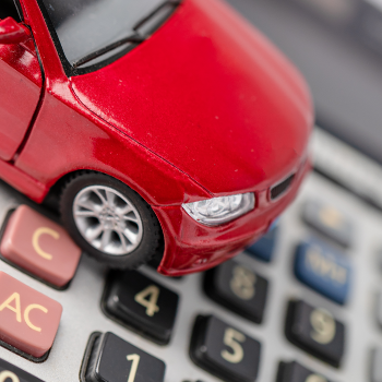 A toy car on calculator travel expenses concept