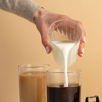 Pouring milk on coffee