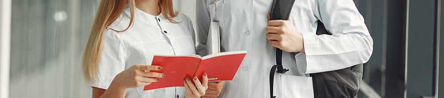 Two medical students looking at a book