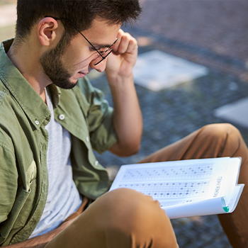 man studying a paper