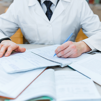 man reading stacks of notebooks