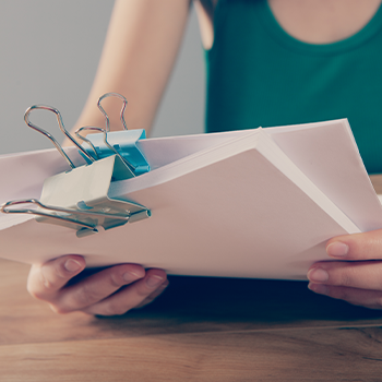 woman reading exam papers