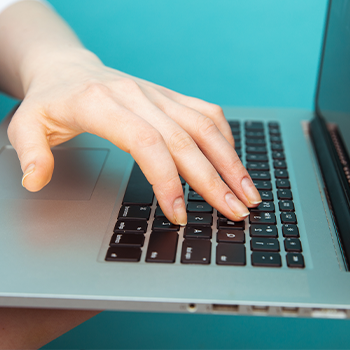 hand view of a person using a laptop