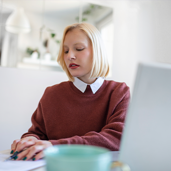 female working with laptop and notes