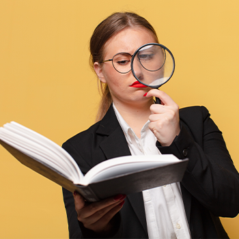 woman carrying a book and a magnifying glass