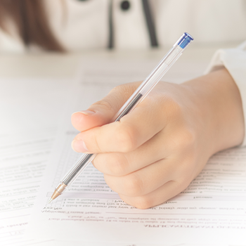 hand view of a student answering a test paper