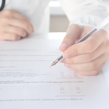 hand view of a person writing on paper