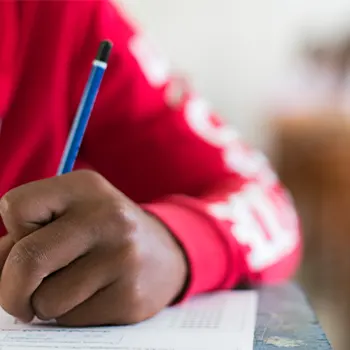 hand view of a person writing on a paper