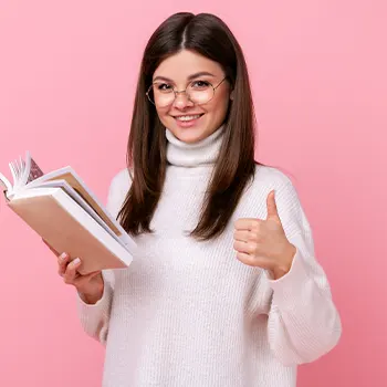 female in glasses giving thumbs up while reading