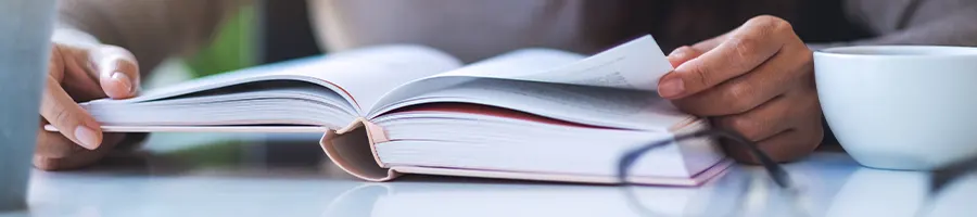 hand view of a woman using a book