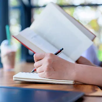 hand view of a person reading and writing