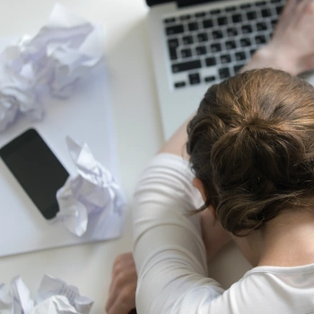 Struggling student resting on her workstation